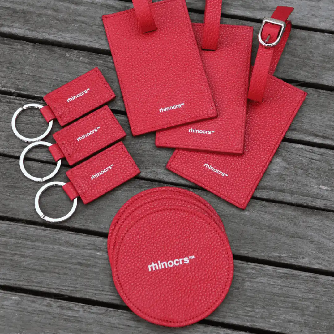 Coordinated set of red branded leather luggage tags, keyrings and card holders made in Italy for a company