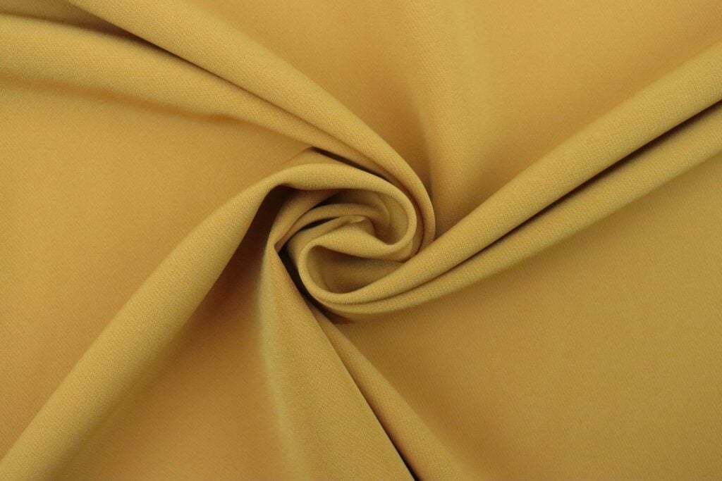 Yellow cupro fabric that is smooth shiney and looks soft to the touch