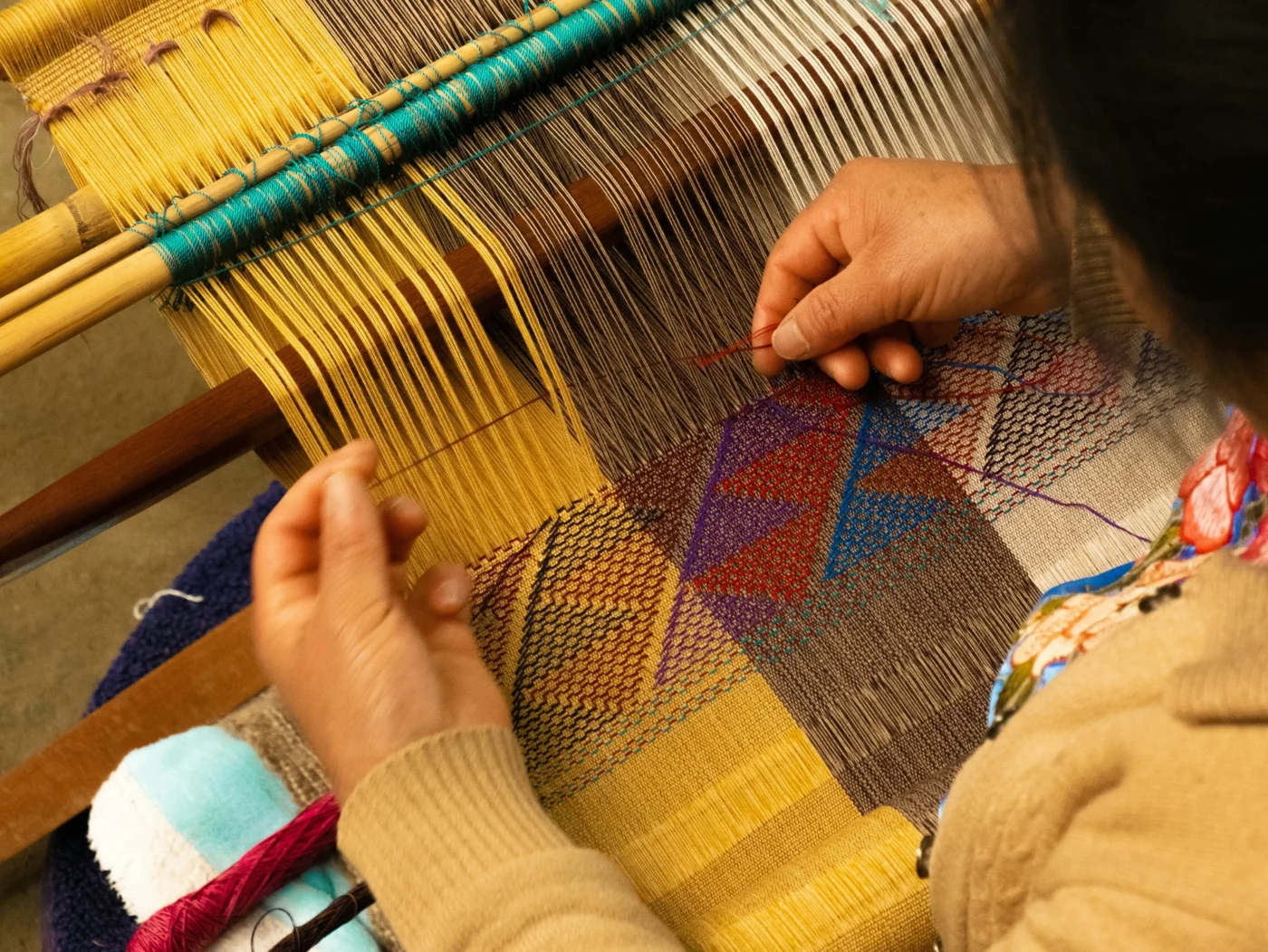 woman weaving fabric