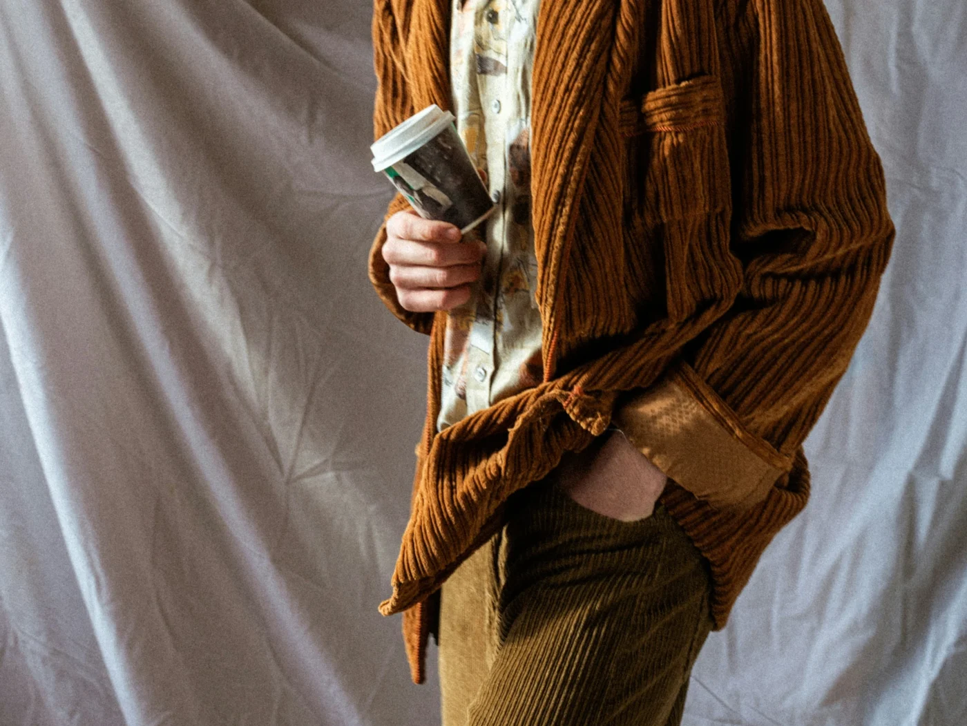 Man wearing corduroy pants and jacket.
