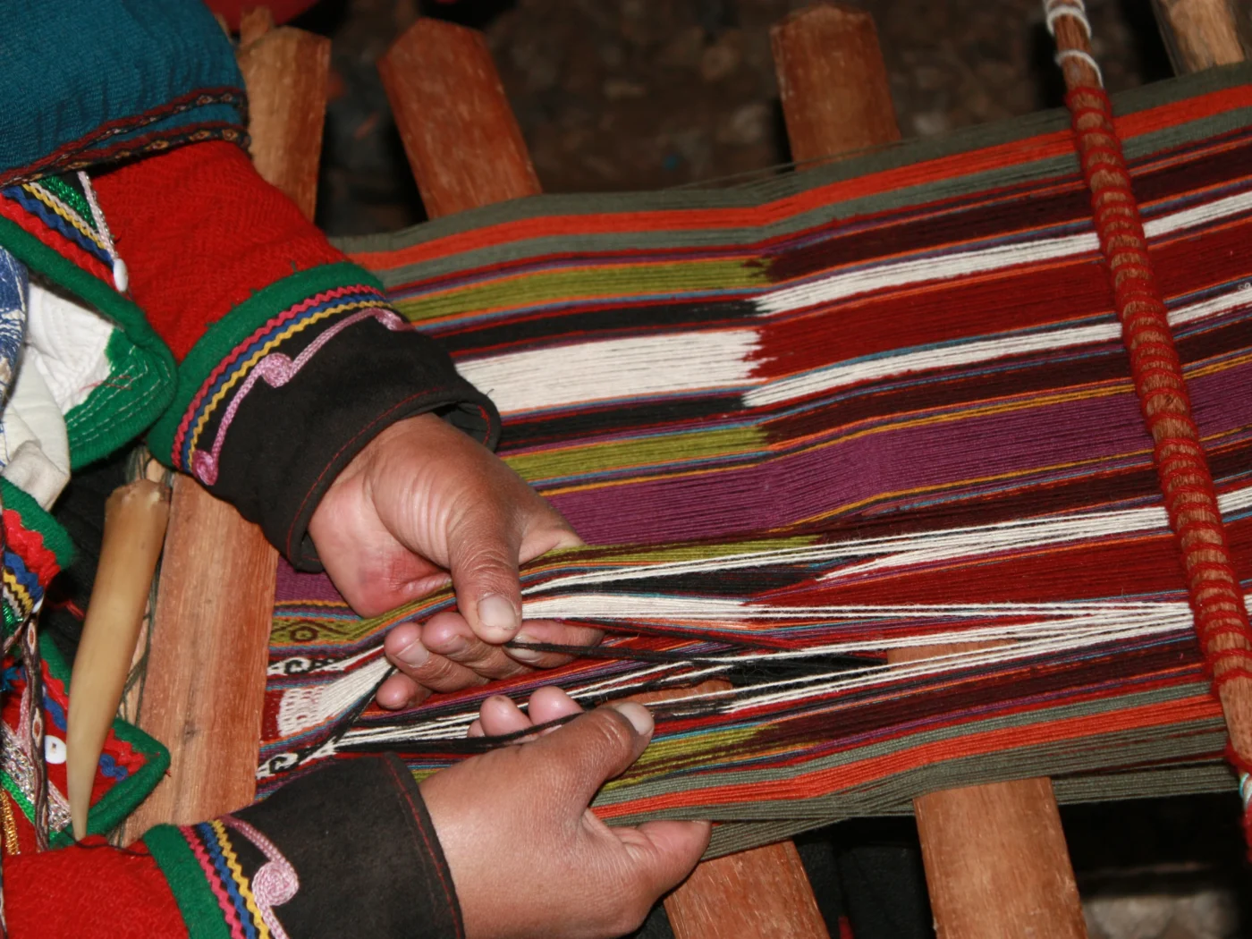 weaving colorful yarn by hand.