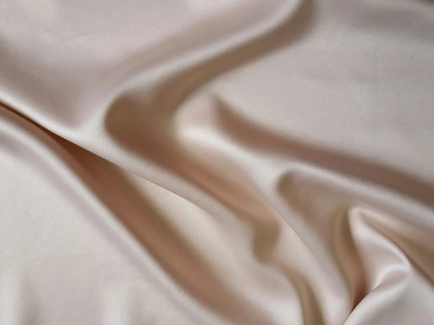 Silky fabric, beige in color.