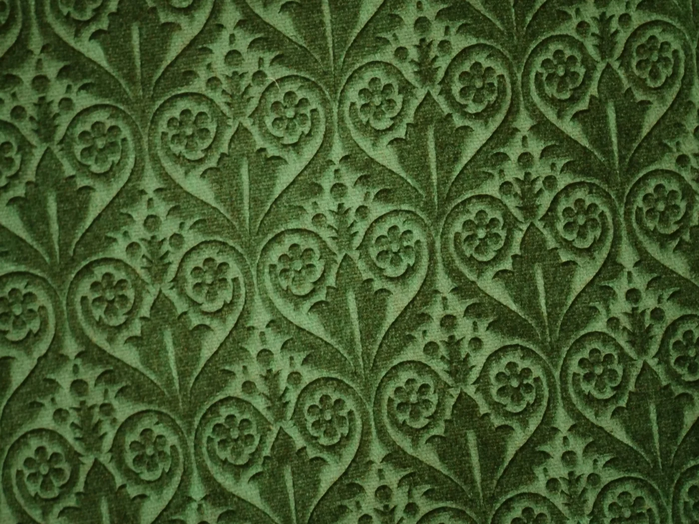 Soft luxurious green fabric with a velvet feel and geometric patterns.