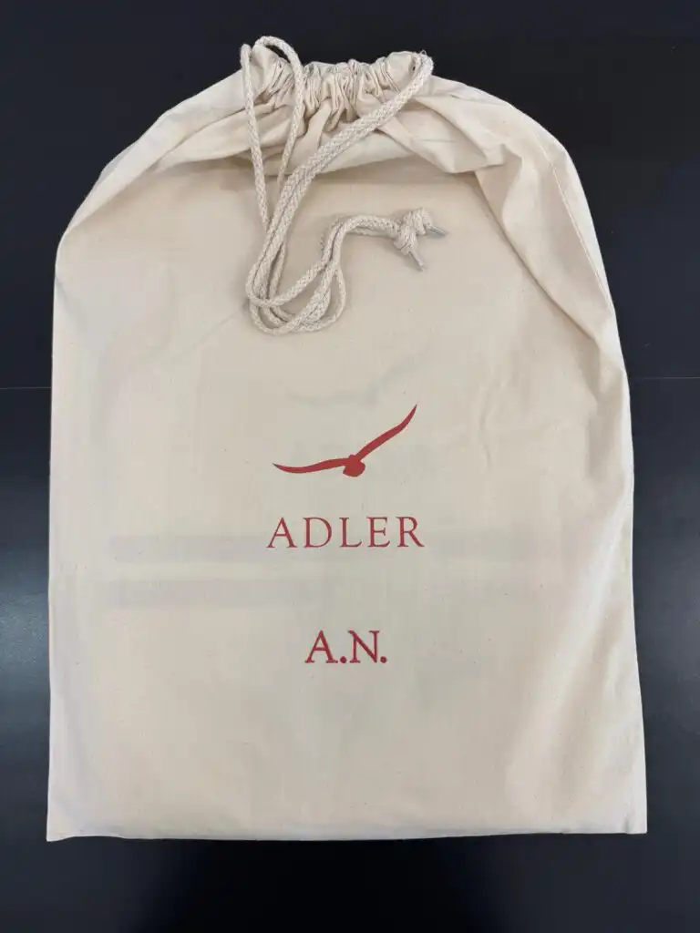 ADLER branded drawstring gift bag with the recipient's initials