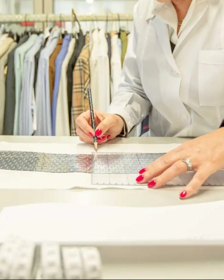 Pattern maker at the cutting table in an Italian clothing workshop