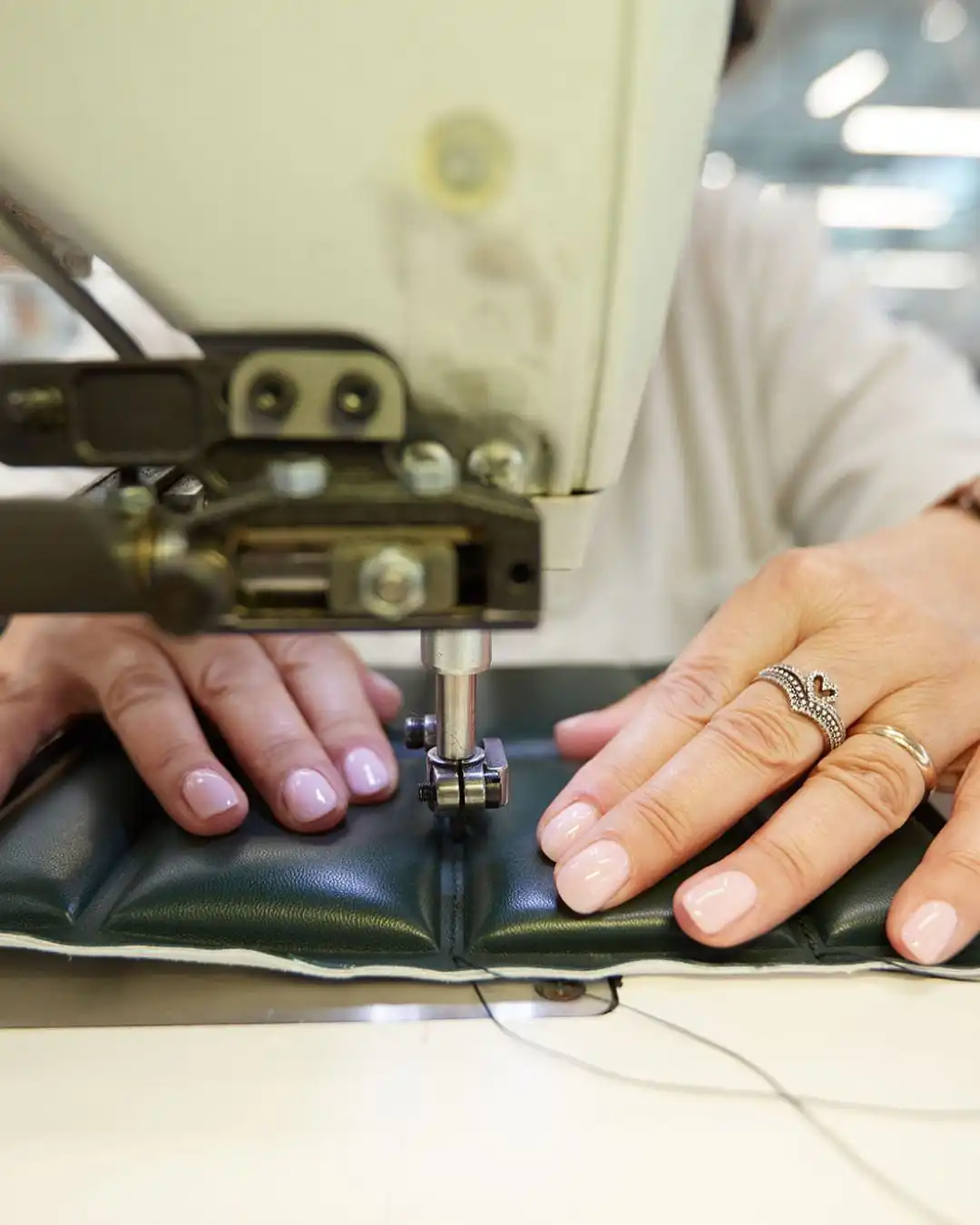Skiving leather on a machine in an Italian leather goods workshop