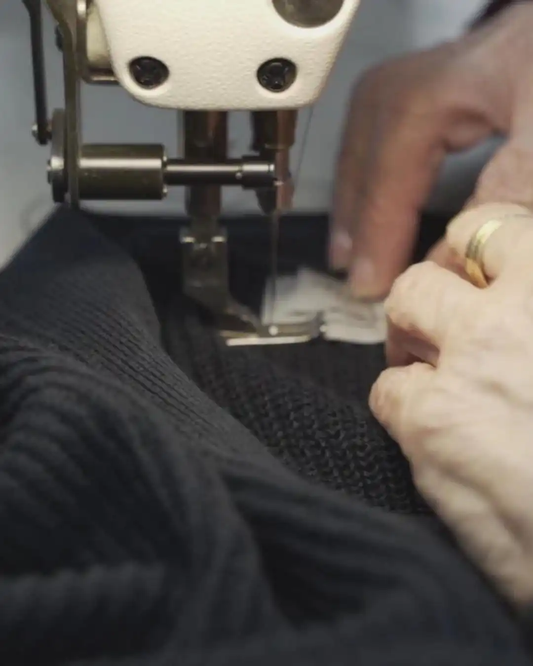 Linking machine joining black knitted panels
