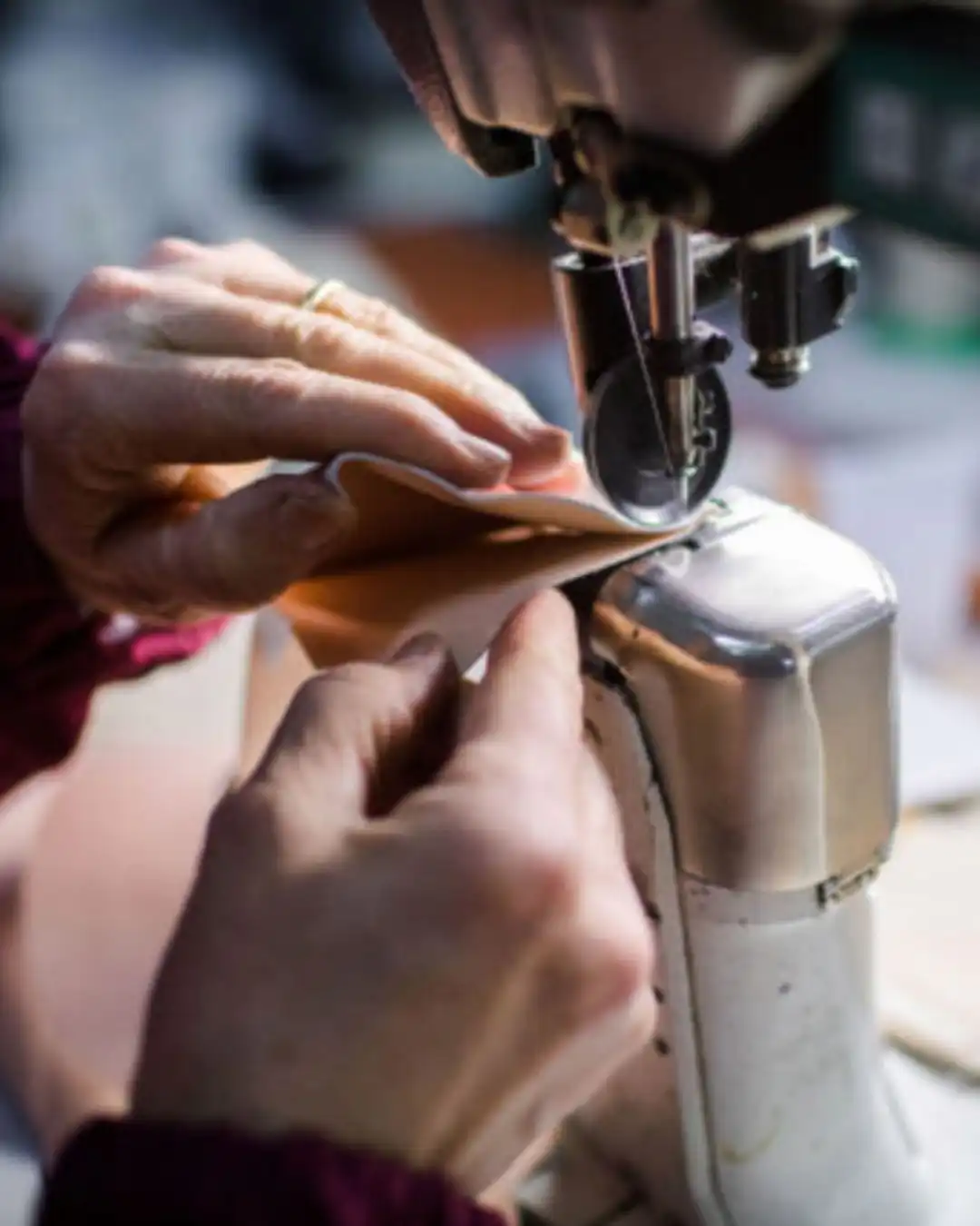 Stitching a leather piece on an industrial sewing machine