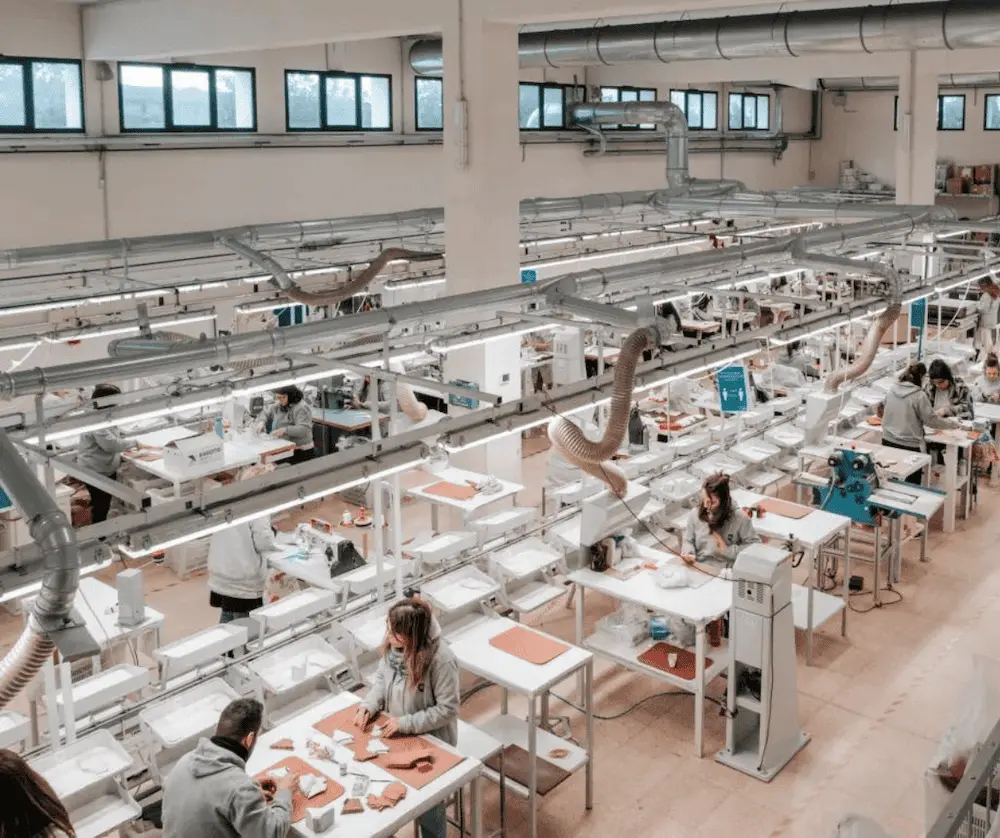 Sewing operators at work on an organized clothing factory production floor