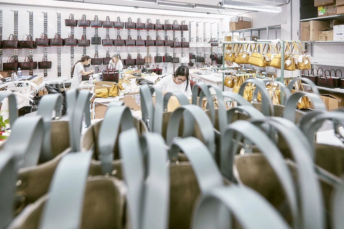 Clothing factory floor seen during a vetting tour, with workstations and machinery.