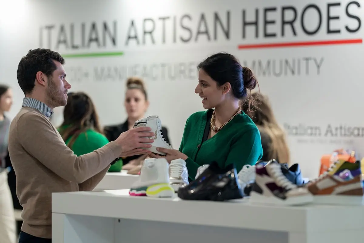 Buyers reviewing fabrics at a textile trade show while sourcing clothing manufacturers