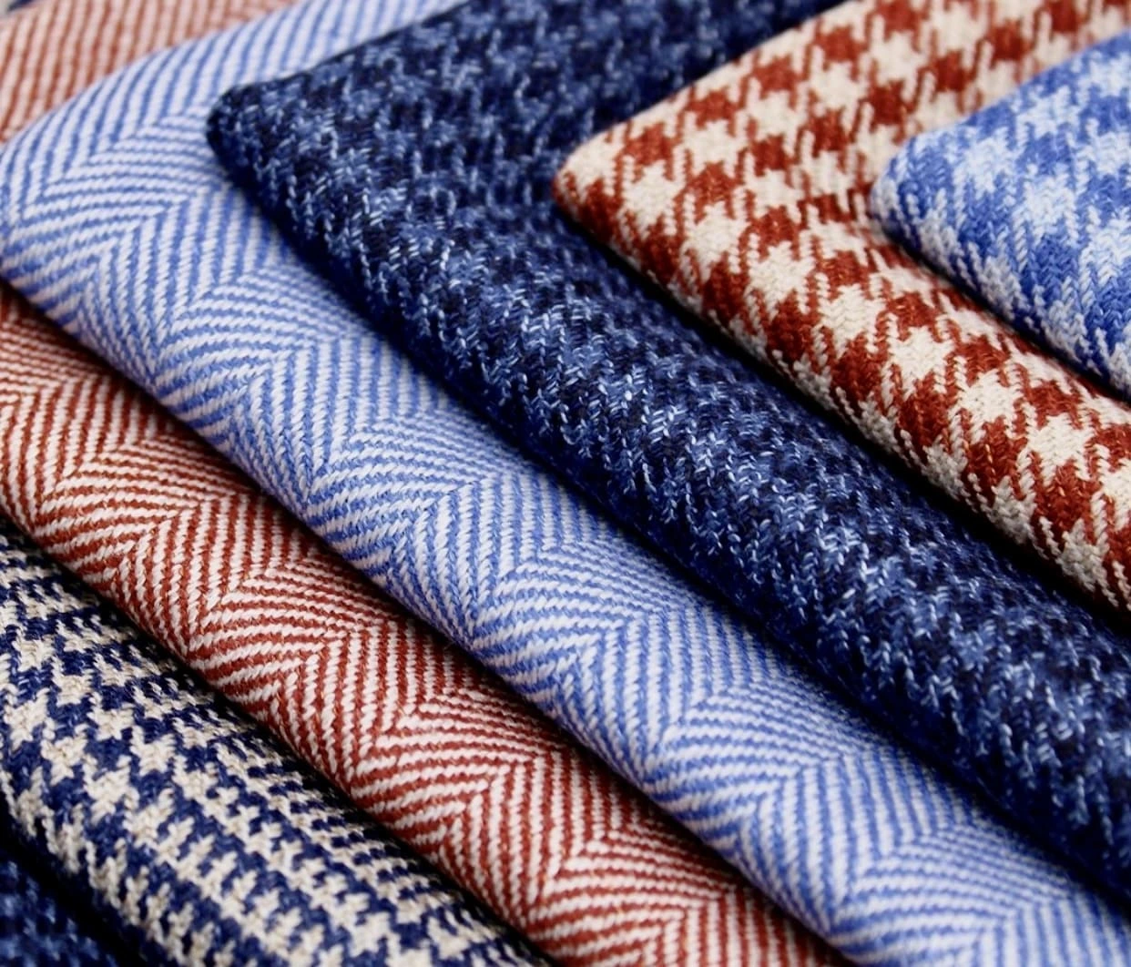 Rolls of fabric in a workshop, the reason CMT minimum order quantities exist.