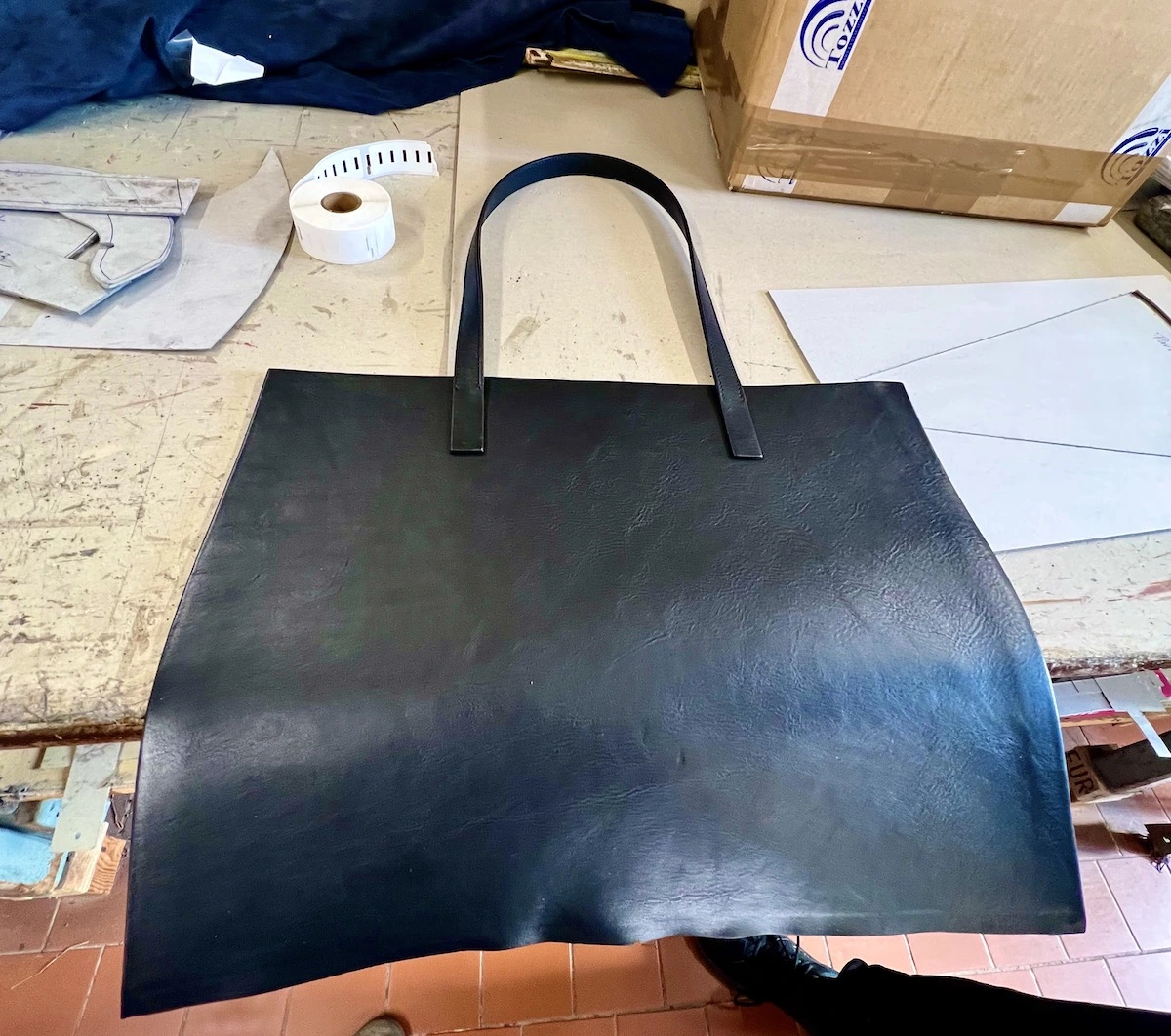 Garment prototype checked for defects during clothing manufacturer sampling.