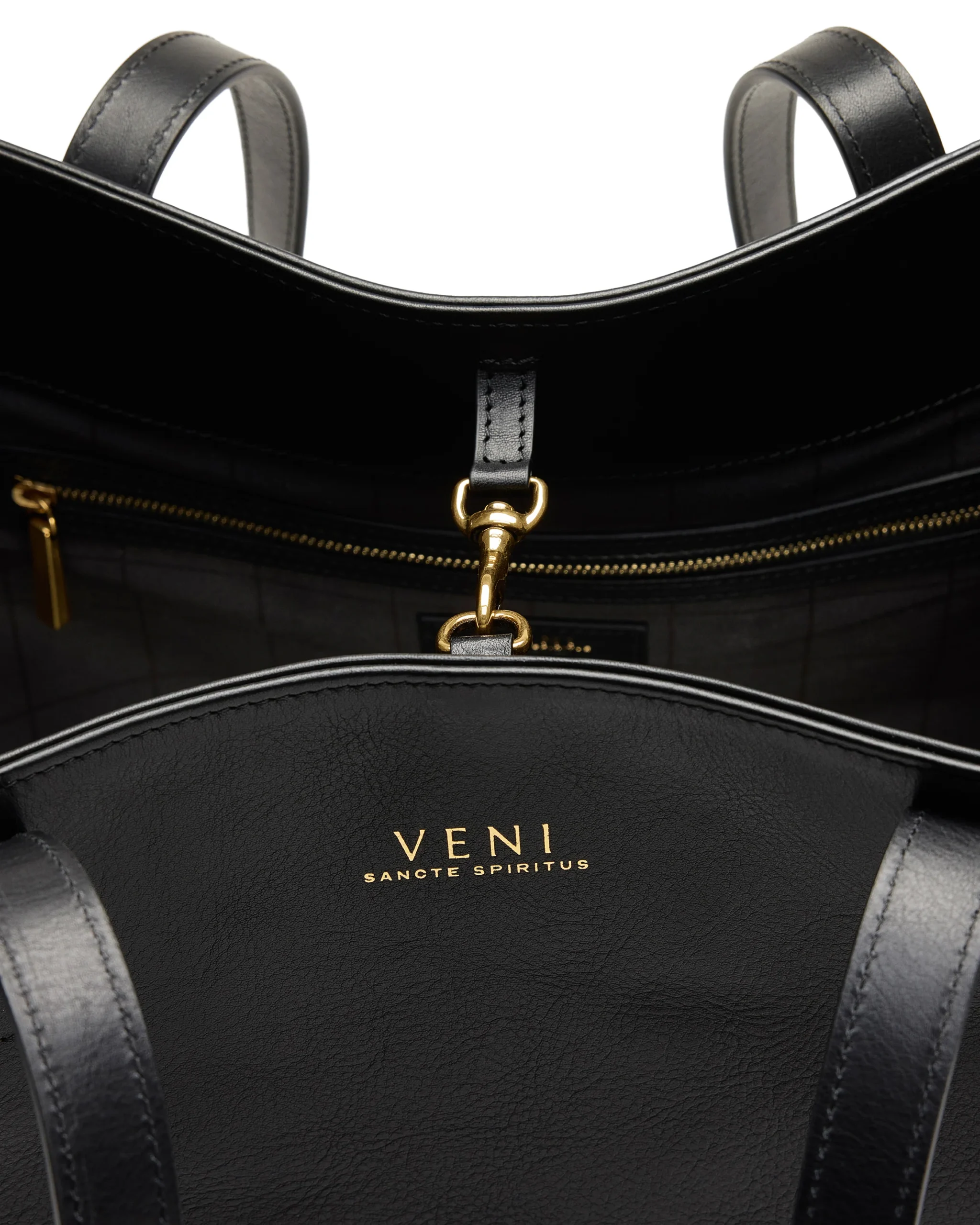 Rebekah tote interior: gold foil Veni logo and brass snap hook on the grid-printed lining