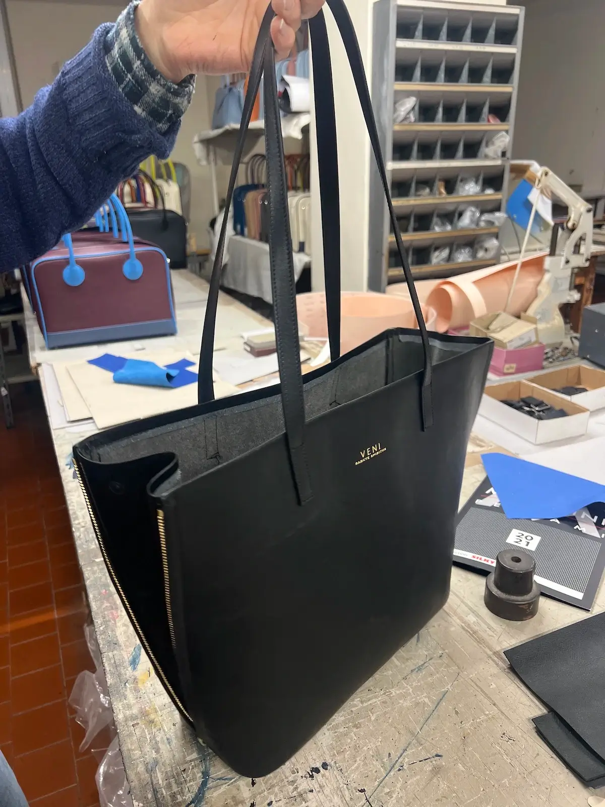 A finished Rebekah tote in the workshop, gold Veni logo on the front