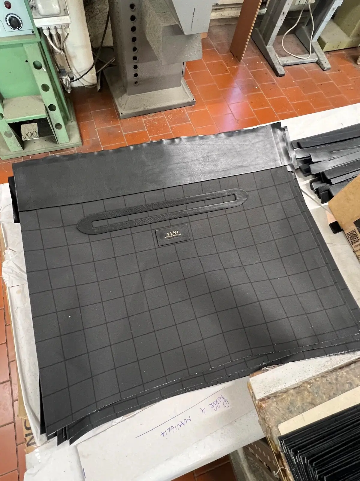 Grid-printed lining panels cut and aligned on the workshop table