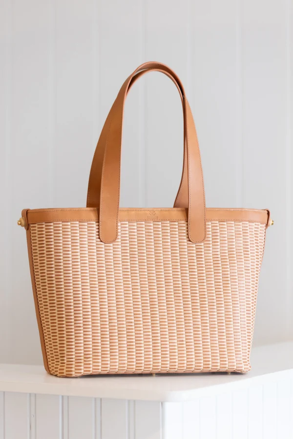 Whale Tail Weaving leather Lightship Basket tote with double leather handles, front view on a white shelf