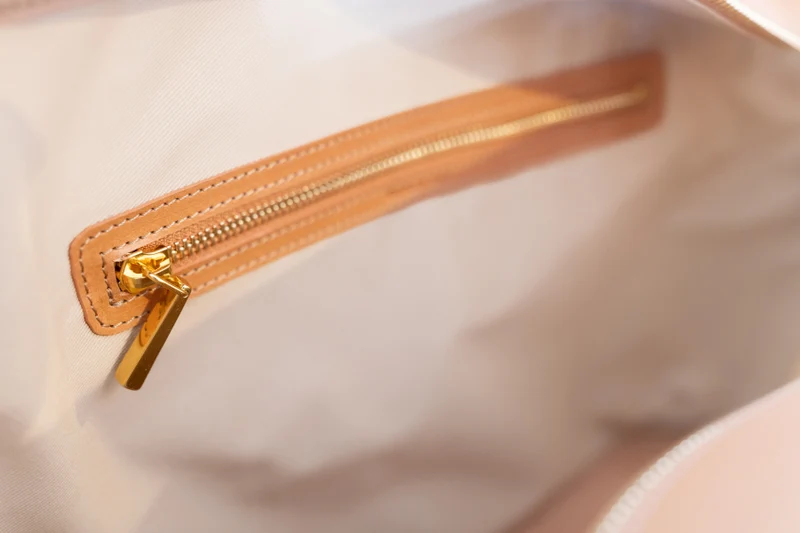 Inside the tote: the hidden zipped security pocket with gold-tone zip