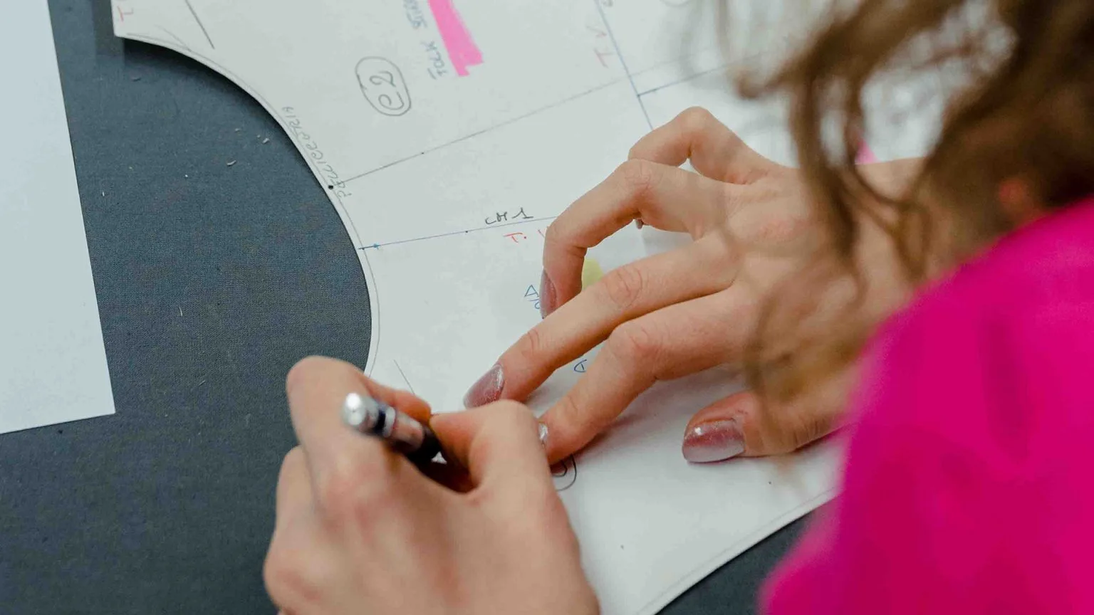 Made in Italy pattern making in a workshop, where the pattern maker works alongside the people who sew.