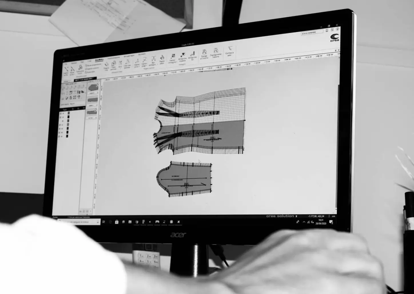 Pattern making on paper: the flat templates for each piece of a garment, with seam allowances and markings.