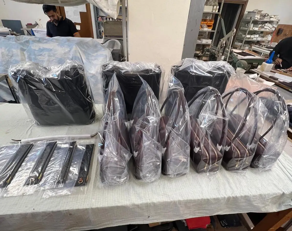 Approved clothing samples kept in an Italian workshop as the production reference for the run