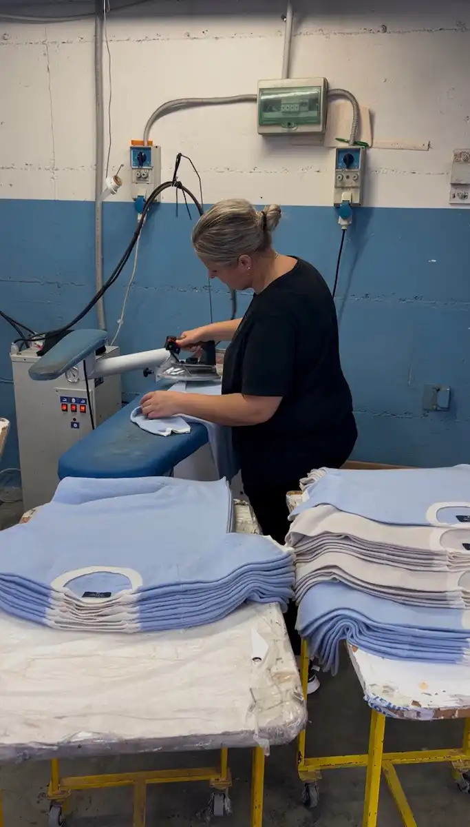 Pressing The Prestige Club t-shirts in an Italian workshop